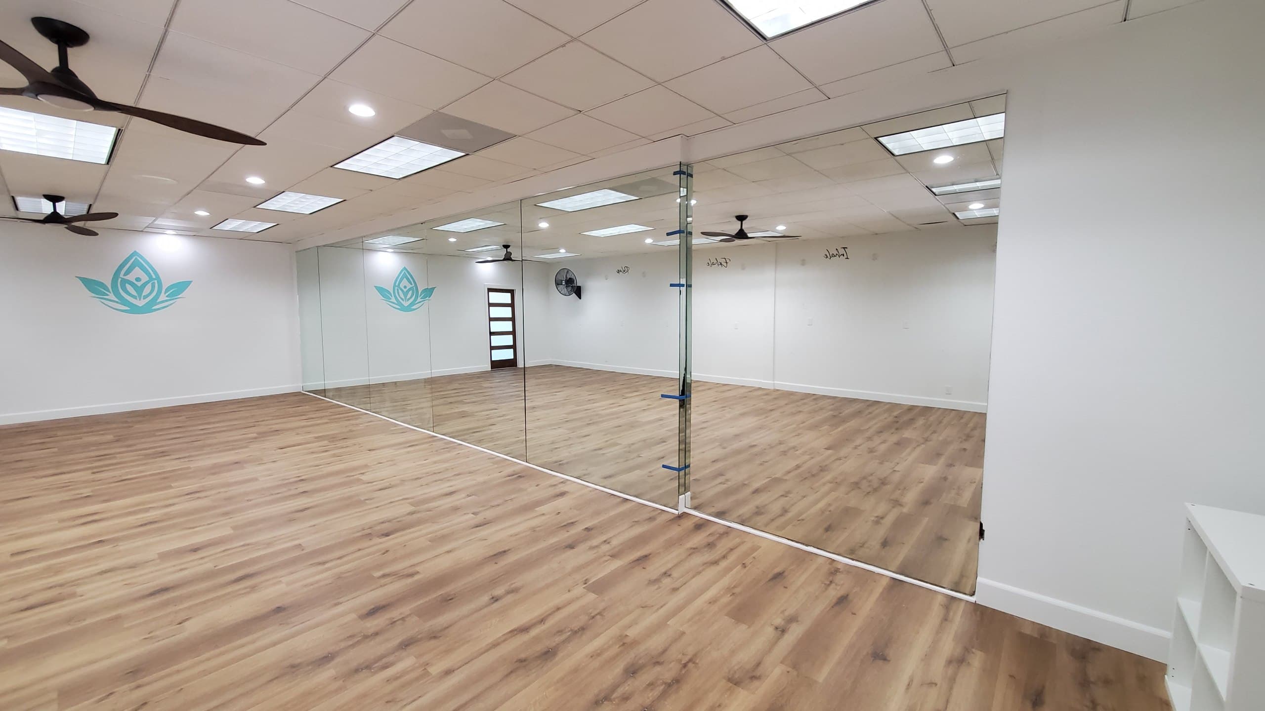 Full-wall mirrors installed the length of a yoga studio